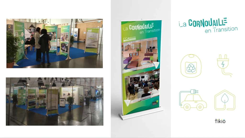 Trade show booths with green banners and visitors viewing displays on a blue carpet indoors.